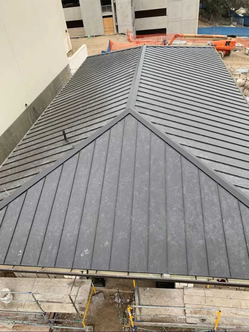 Commercial metal roof construction with crane equipment in Glennville