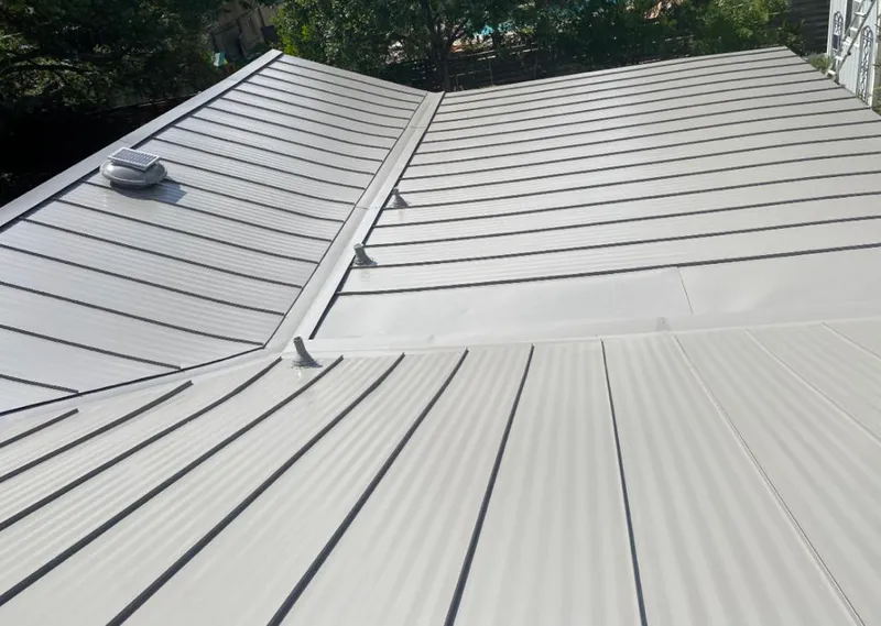 Solar attic fan installed on a metal roof for Roof Ventilation in Glennville